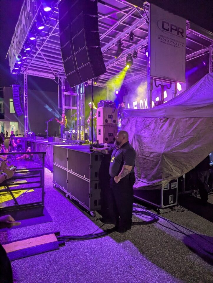 Stage security in action — eyes on the crowd, not the performance. TESS Global team member at post during a live concert at our Florida venue.